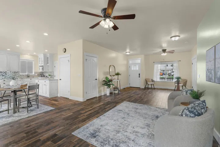 Open-concept living area featuring wood-finish flooring, recessed lighting, and multiple ceiling fans
