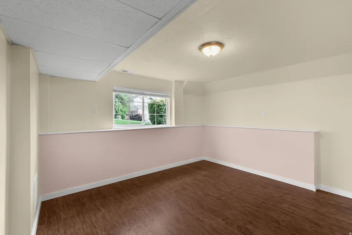 Recessed lighting, wood-finish flooring, drop ceiling, and a prominent window