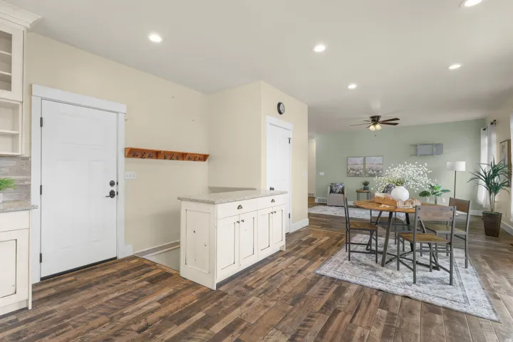 Wood-finish flooring throughout, recessed lighting, and a built-in cabinetry with a light-toned countertop