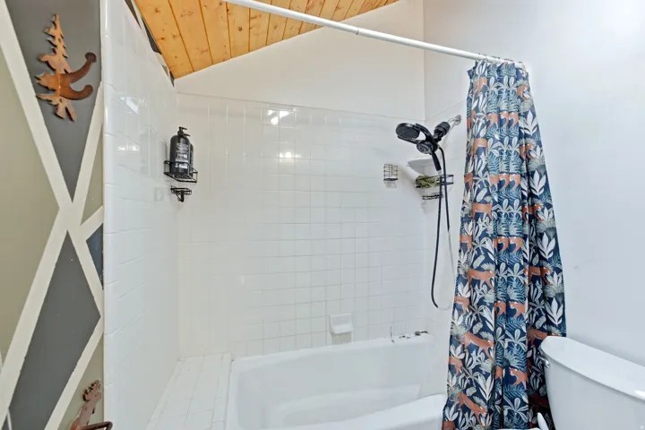 White tile shower surround with integrated tub