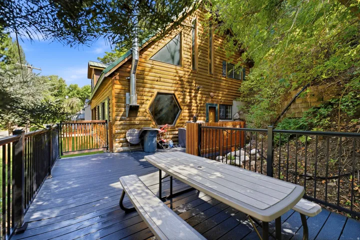Wood log cabin exterior with a metal roof