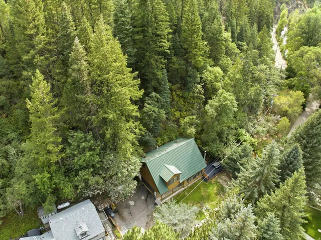 Wood-sided exterior with a green metal roof