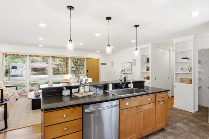 Kitchen island with an undermount sink and stainless steel dishwasher