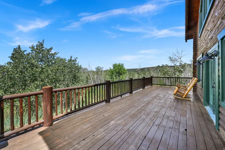 Expansive wood deck with a natural wood railing