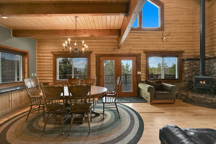 Log wall construction with exposed wood beams