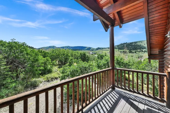 Expansive wooden balcony featuring durable wood flooring and a sturdy wood railing