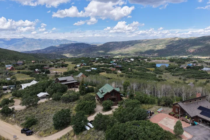 Expansive mountainous landscape with a community of homes nestled among natural foliage