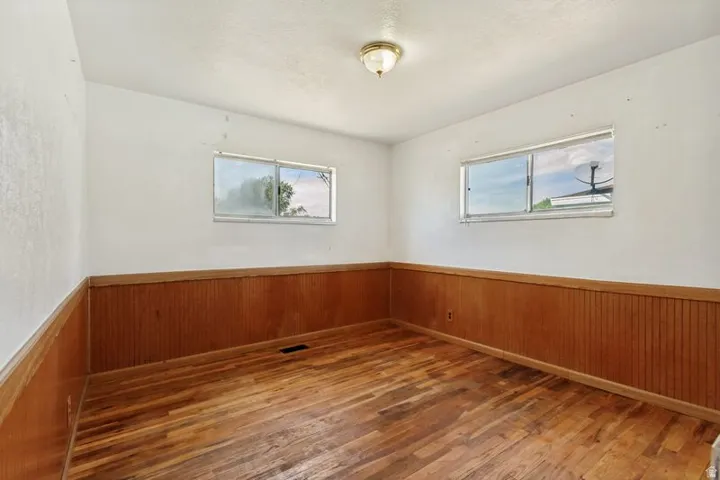 Wood-finish flooring with wood panel wainscoting