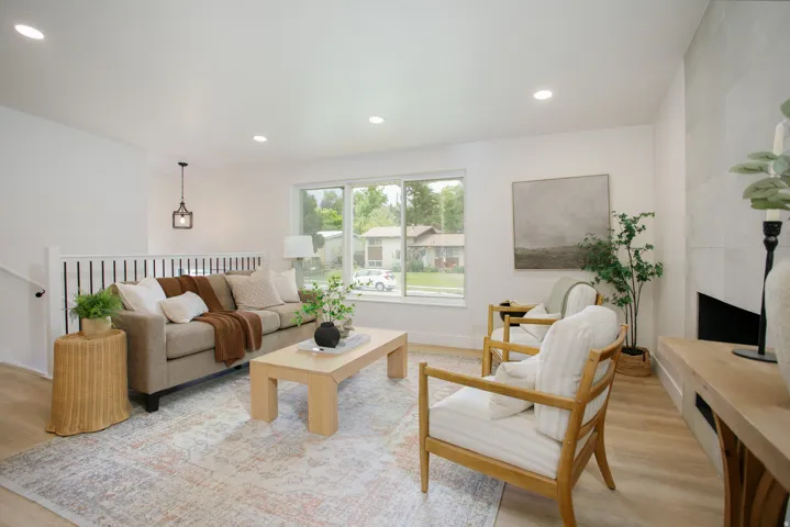 Bright, open living space anchored by wood-finish flooring and recessed ceiling lighting