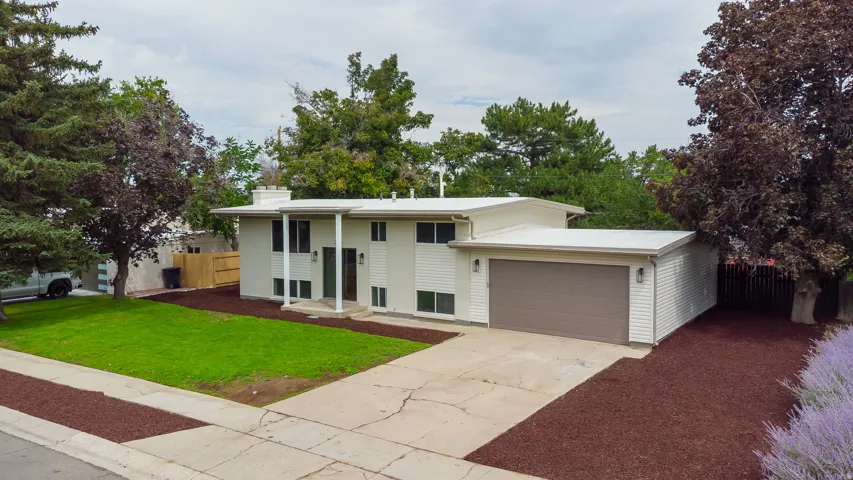 Contemporary exterior with white siding and dark trim