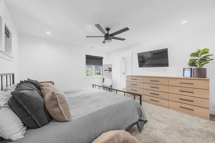White walls with recessed lighting and a ceiling fan