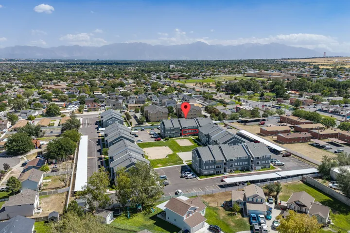 Aerial perspective of a developed community with multi-story buildings and covered parking