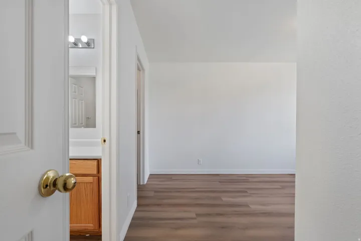 Wood-finish flooring with white baseboards