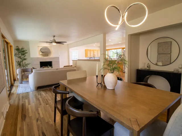 Recessed dining area with a contemporary chandelier, featuring hardwood flooring throughout