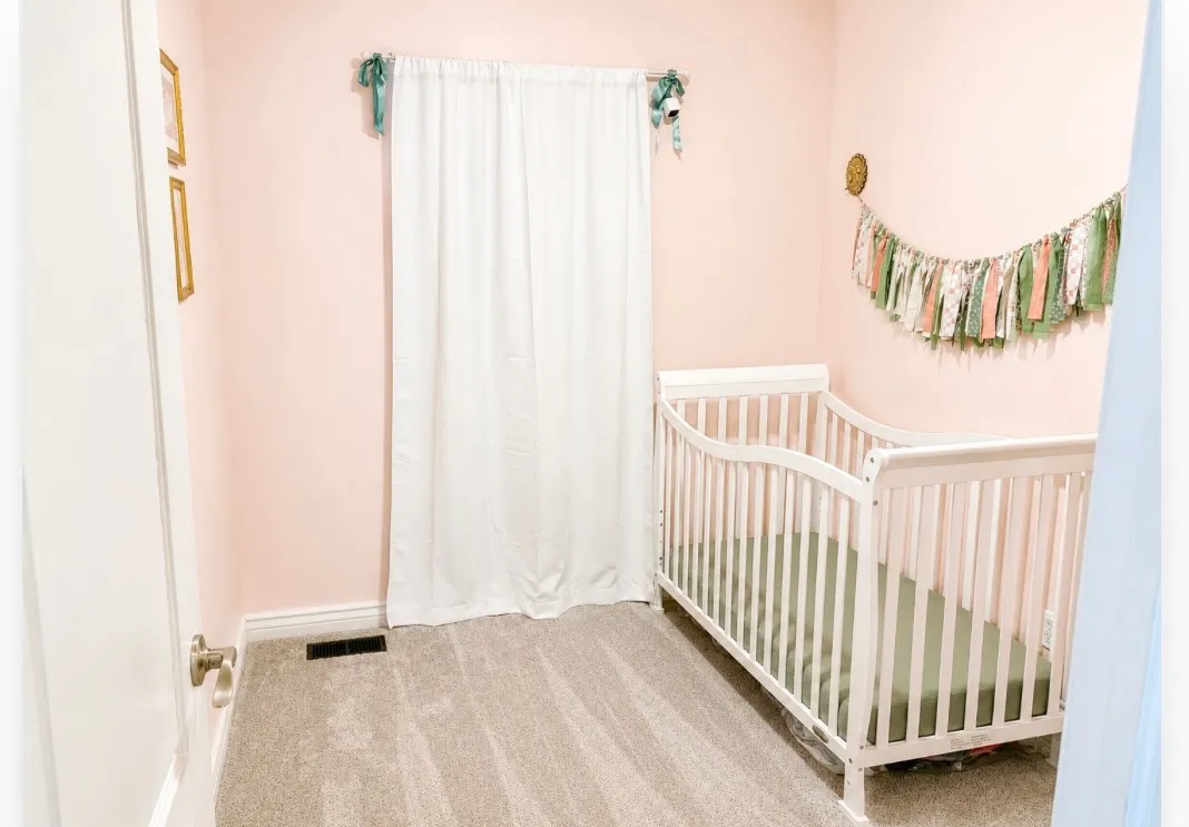 Wall-to-wall carpeting with light-colored walls and white trim