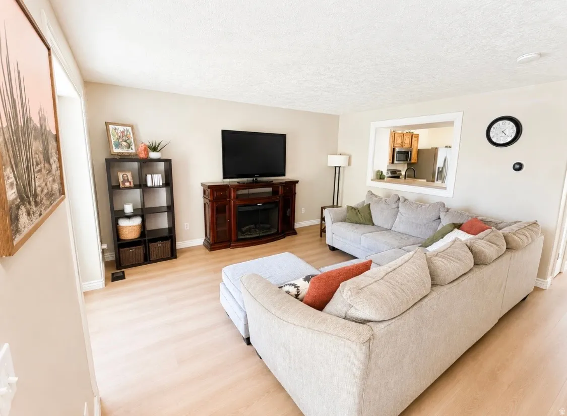 Light wood-finish flooring complements neutral wall tones
