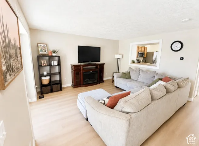 Light wood-finish flooring complements neutral wall tones