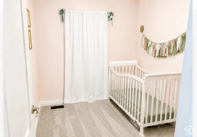Wall-to-wall carpeting with light-colored walls and white trim