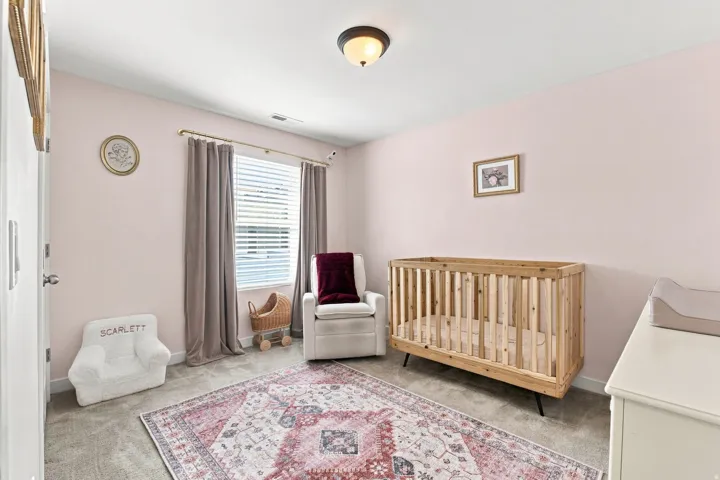 Recessed lighting with a semi-flush mount fixture, window with horizontal blinds, neutral wall-to-wall carpeting, and light pink painted walls