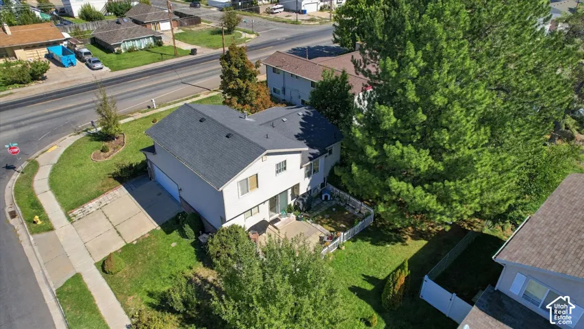 Two-story residence with a gray shingle roof, attached garage, and a concrete driveway