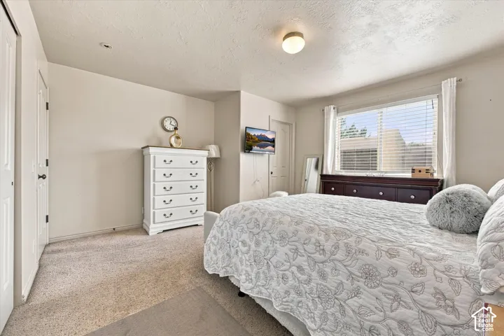 Carpeted flooring, recessed lighting, and a window with blinds