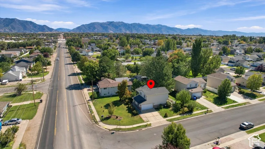 Property featuring a two-story residence, attached garage, and paved driveway