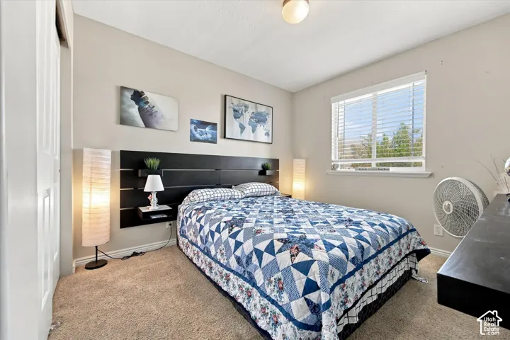 Wall-to-wall carpeting, window with blinds, and flush mount lighting