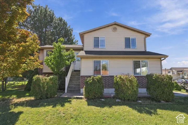 Two-story exterior with horizontal siding and brick accents