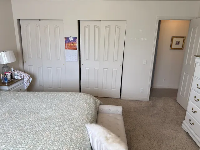 Other view of the Master Bedroom. Wall-to-wall carpeting and white bi-fold closet doors