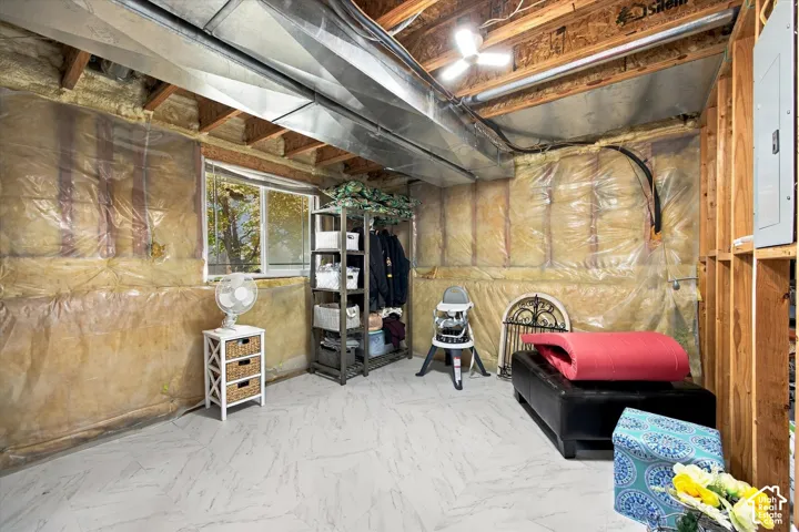 Potentially 4th bedroomBasement area featuring a window, exposed ceiling joists, and a utility panel