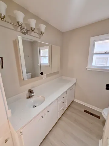 Extended vanity with a single basin sink and brushed nickel faucet