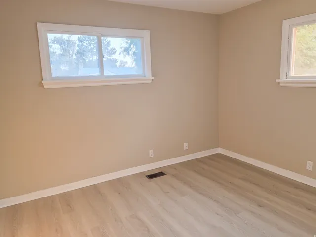 Wood-finish flooring with neutral wall tones and white trim