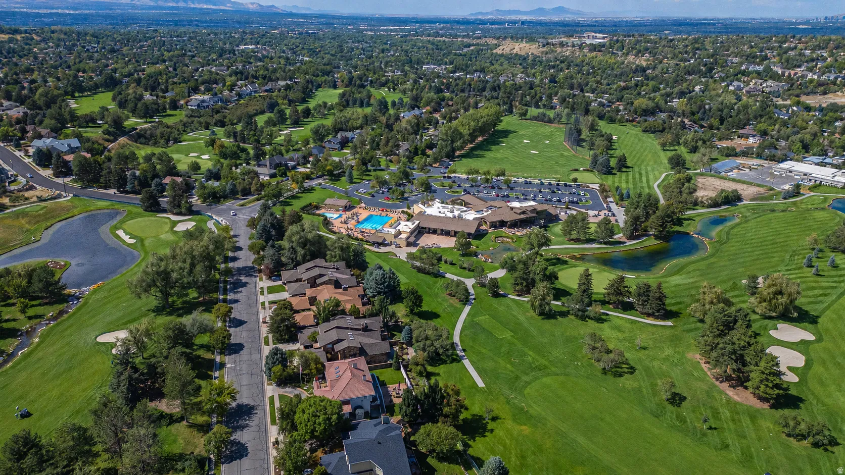 Expansive golf course setting with multiple greens and sand traps