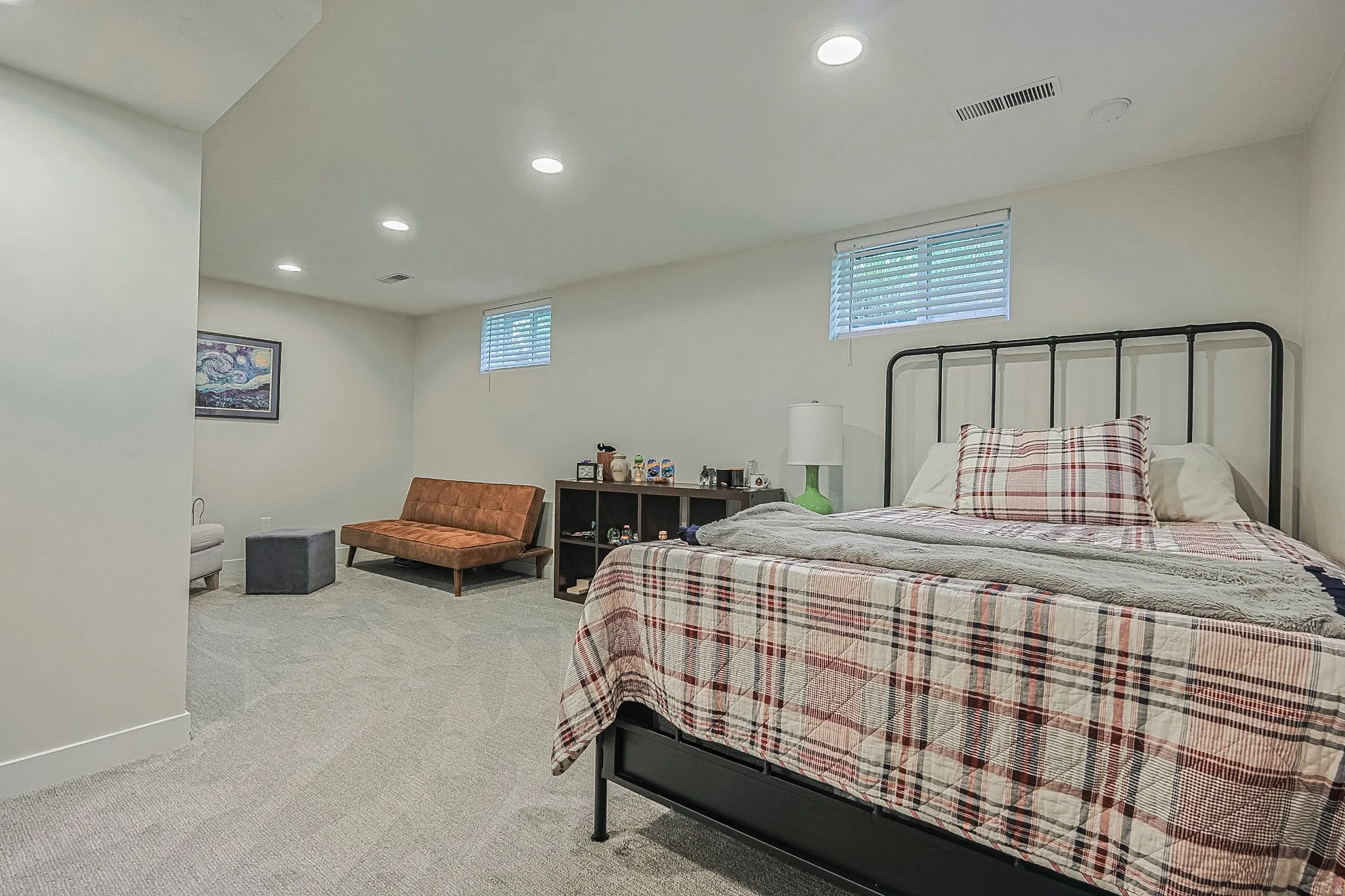 Recessed lighting, light gray carpet, and two windows with blinds