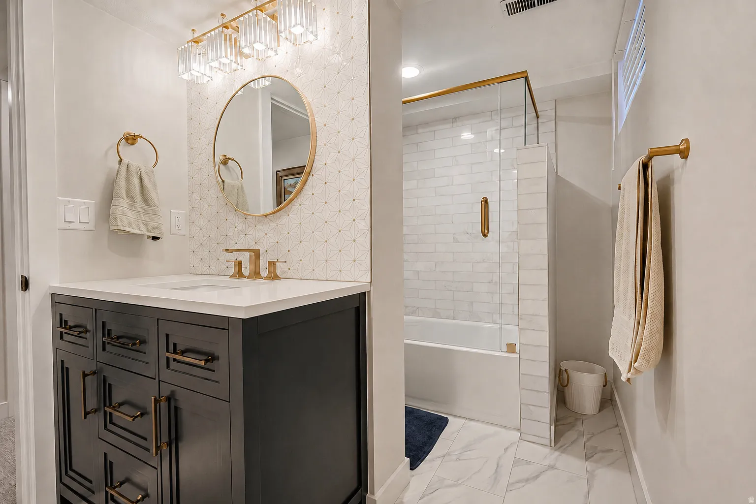 Vanity with a white countertop and gold-finish fixtures