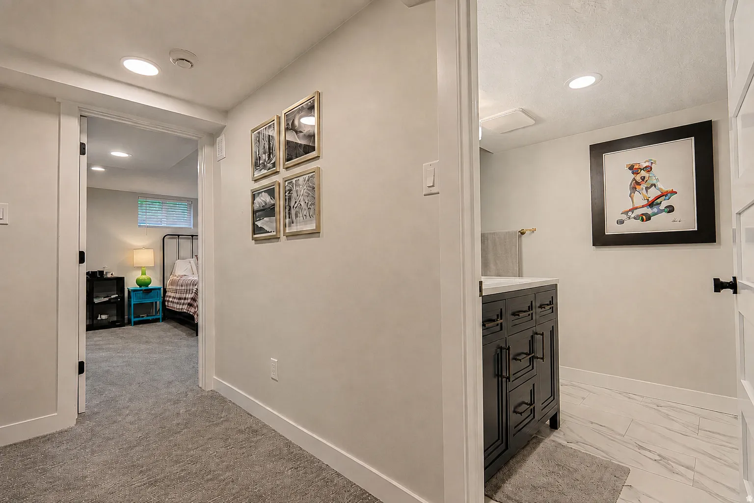 Recessed lighting, wood-finish vanity with countertop, light-toned flooring, carpeting, and a white interior door
