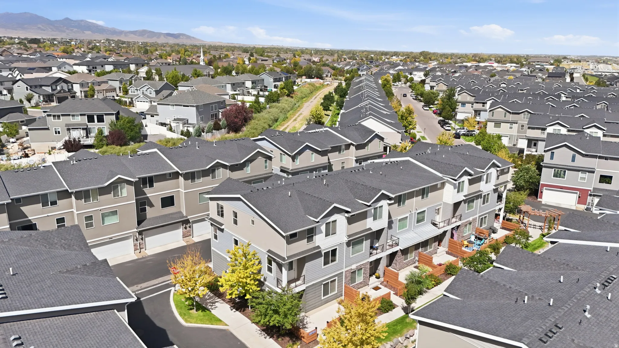 Multi-level townhome architecture with a stone and siding exterior