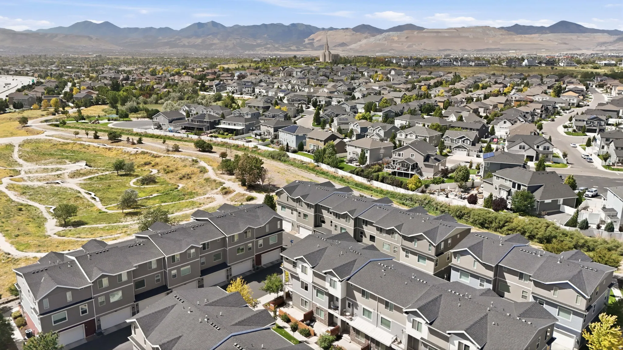 Townhome community featuring multi-story residences with attached garages and pitched roofs