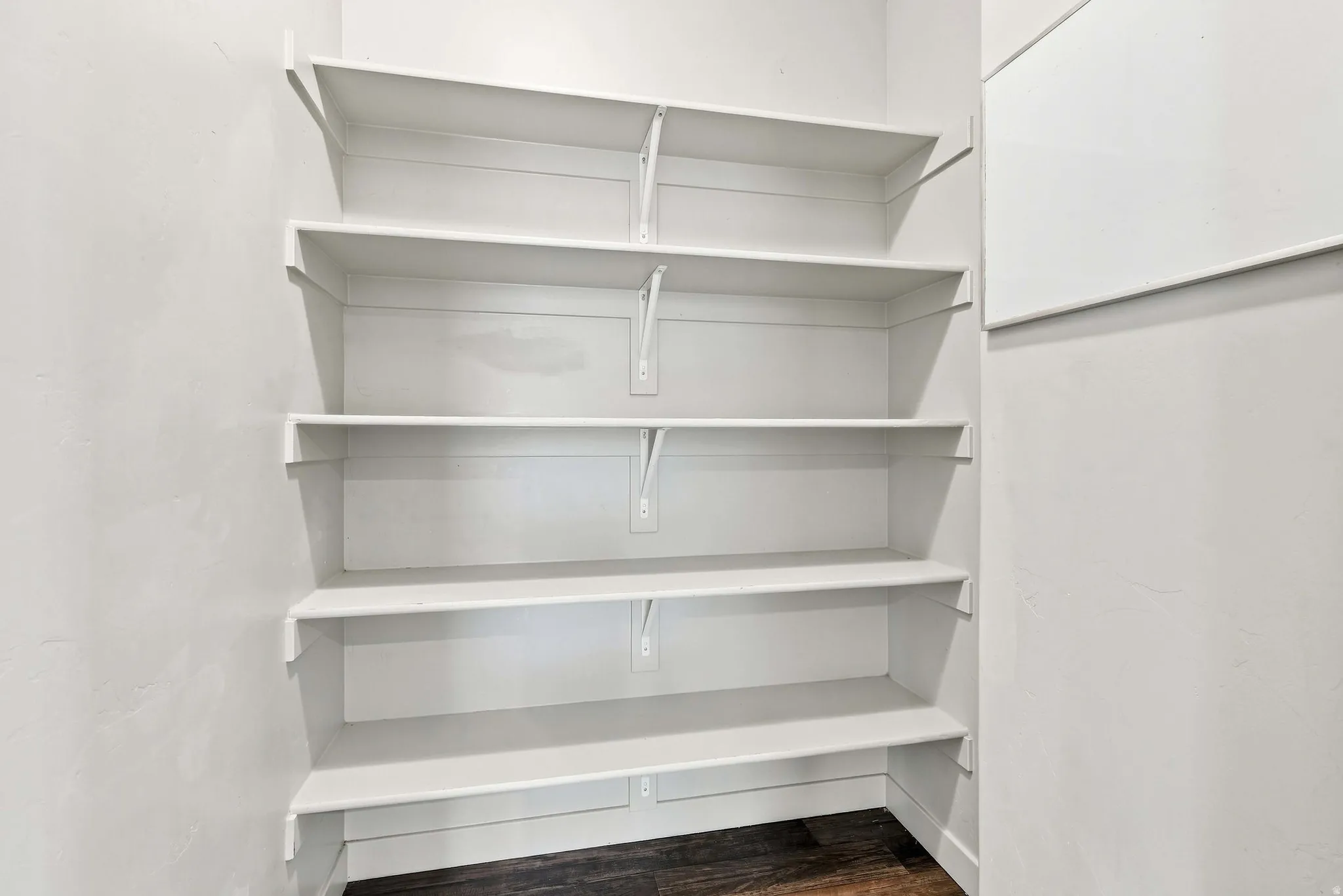 Built-in white shelving system with multiple tiers