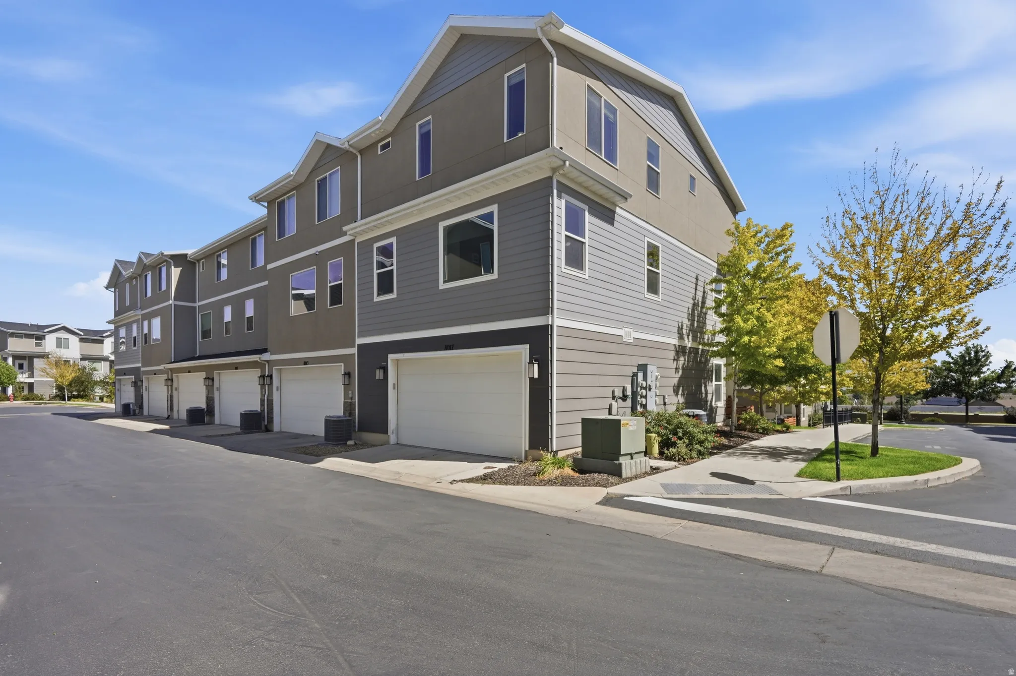 Multi-story townhome exterior featuring contemporary siding and multiple windows