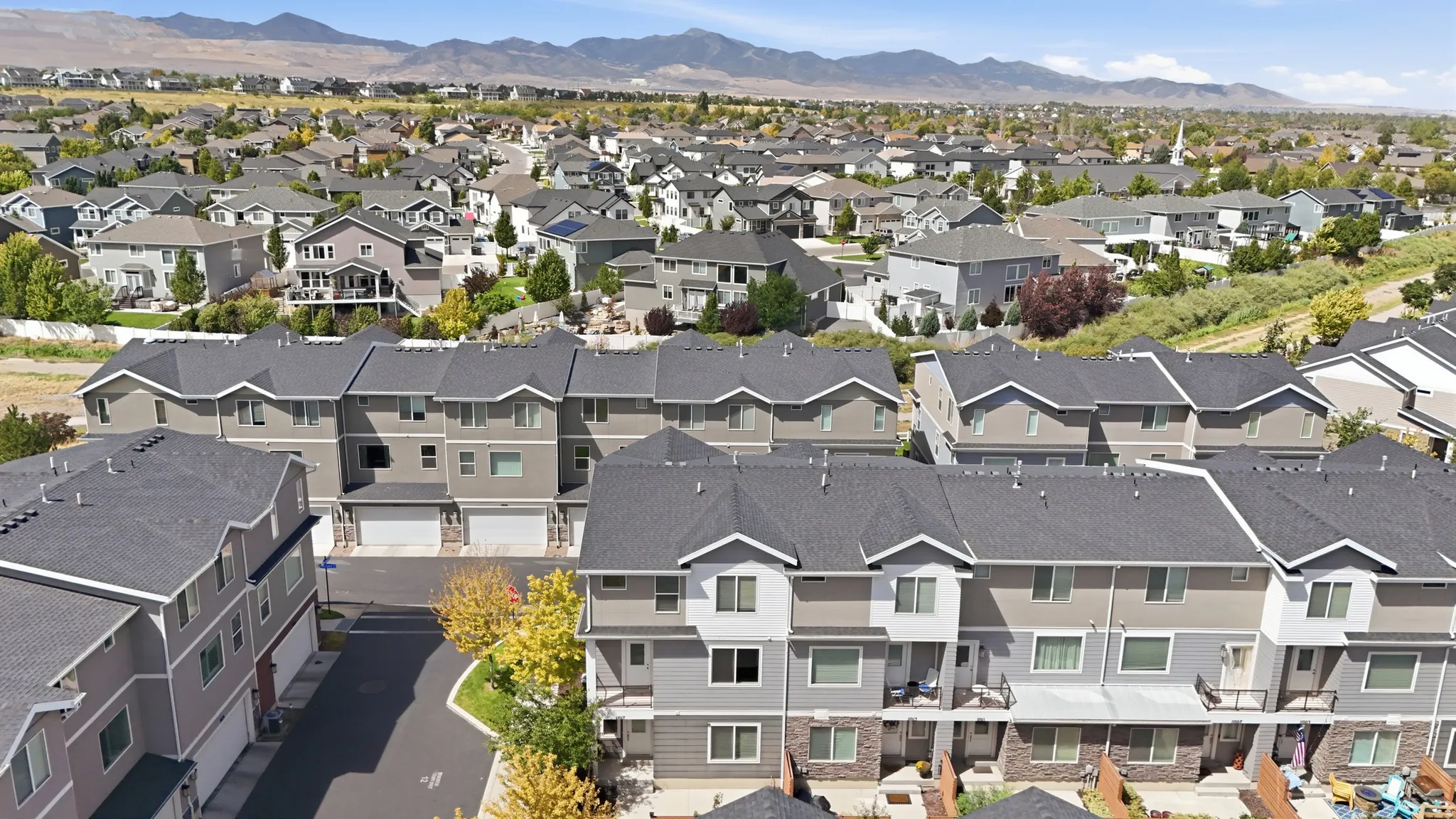 Multi-level townhome community with attached garages and balconies