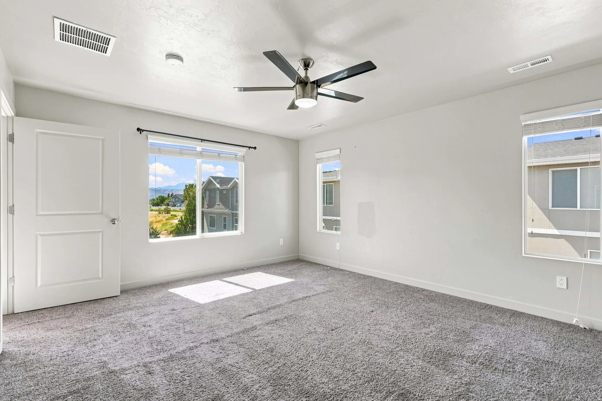 Room with neutral carpeting and light-colored walls