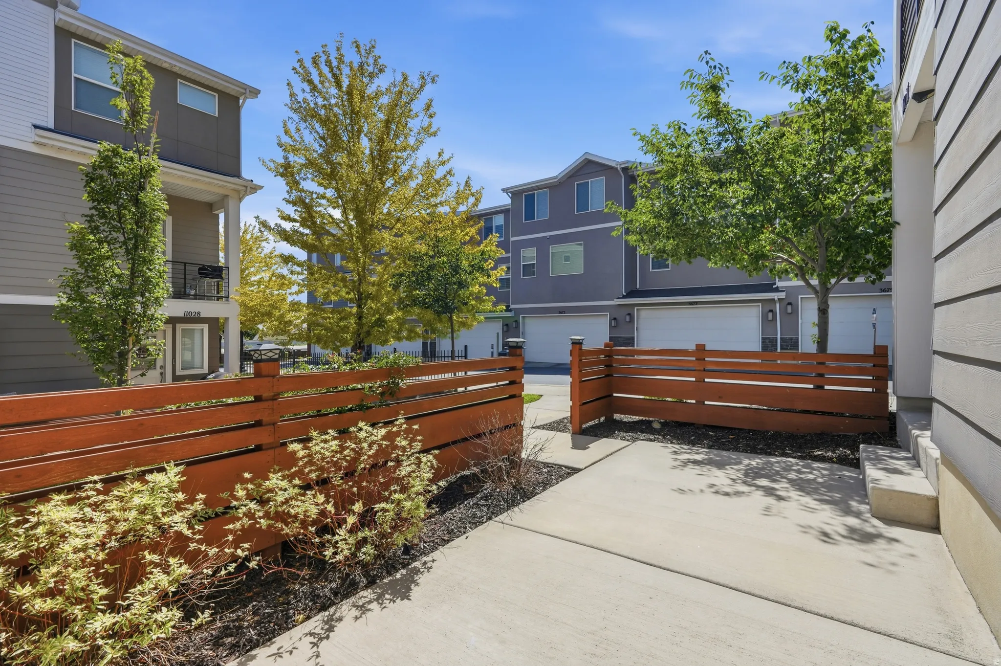 Concrete patio with a slatted privacy fence