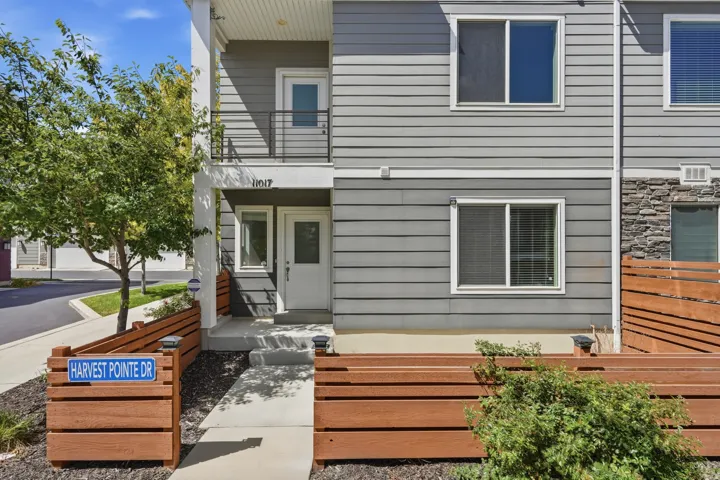 Contemporary facade with gray horizontal siding and stone accents