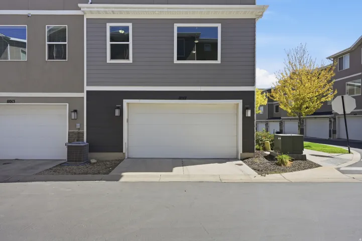 Two-story exterior with horizontal siding and a white garage door