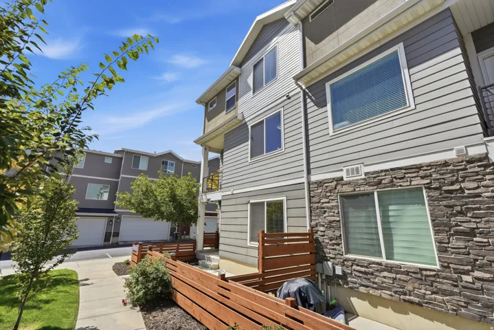 Multi-level exterior with horizontal siding and stacked stone accents