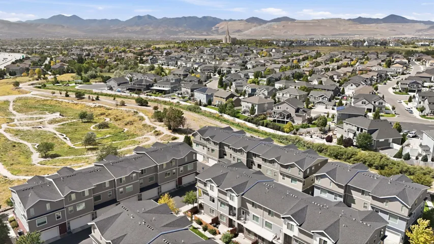 Townhome community featuring multi-story residences with attached garages and pitched roofs