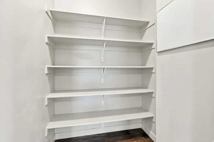 Built-in white shelving system with multiple tiers