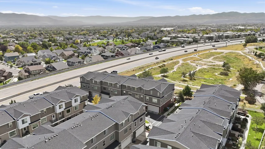 Contemporary townhome community featuring multiple stories and a neutral color palette