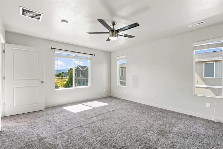 Room with neutral carpeting and light-colored walls